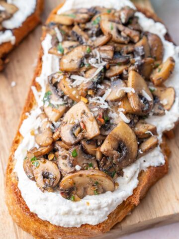 Mushroom toast on a wooden board.