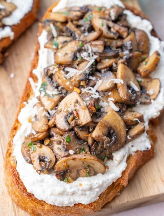 Mushroom toast on a wooden board.