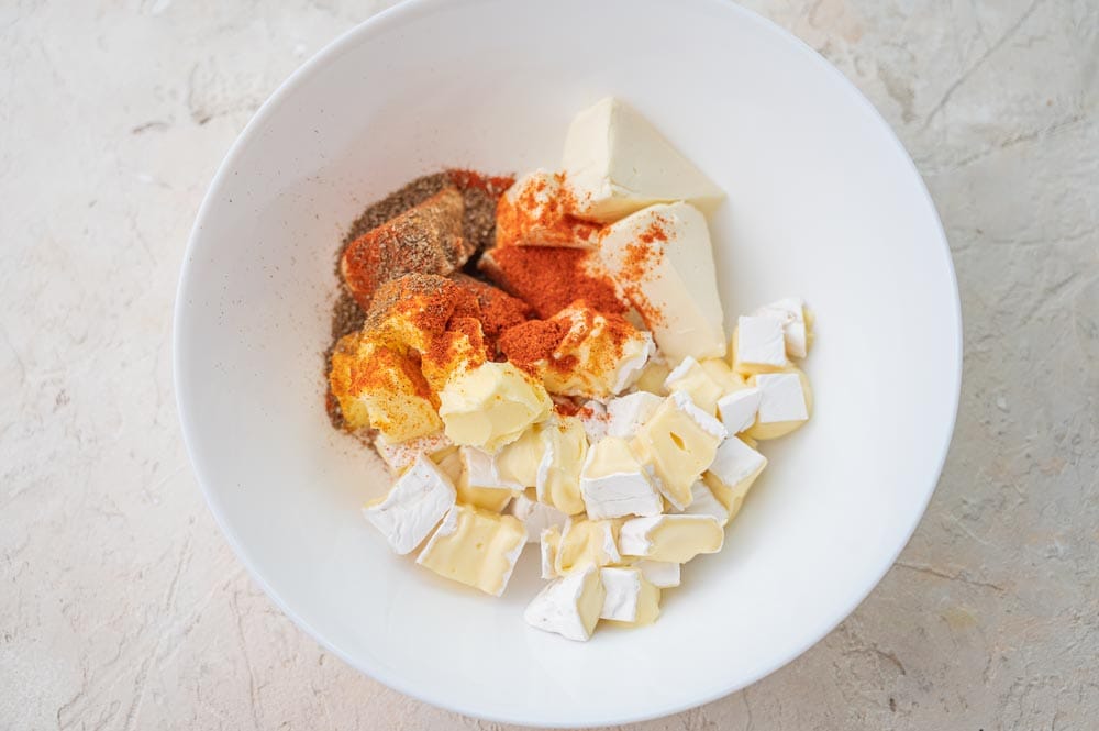 Ingredients for Obatzda dip in a white bowl.