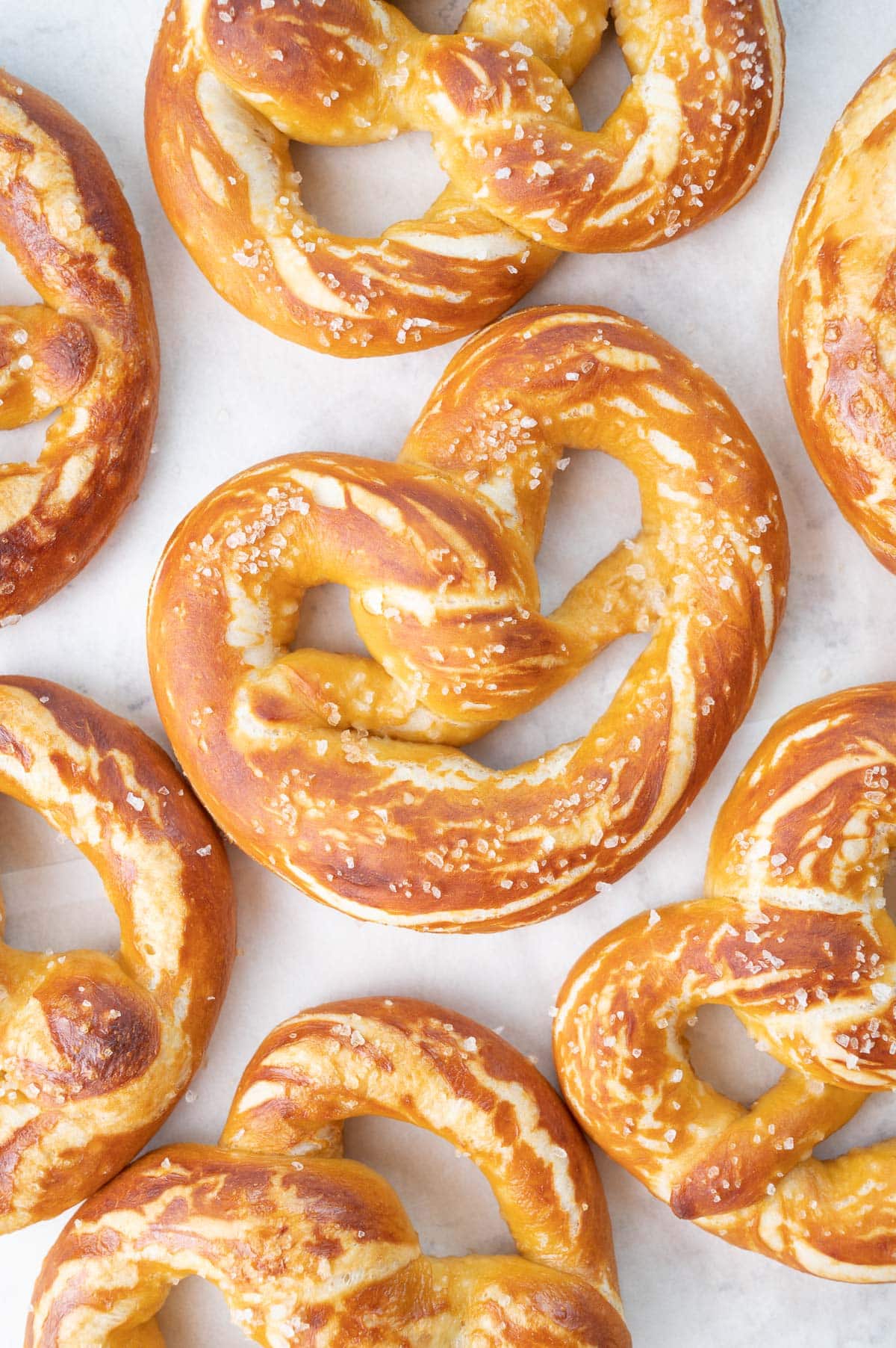 Soft pretzels on a piece of parchment paper.