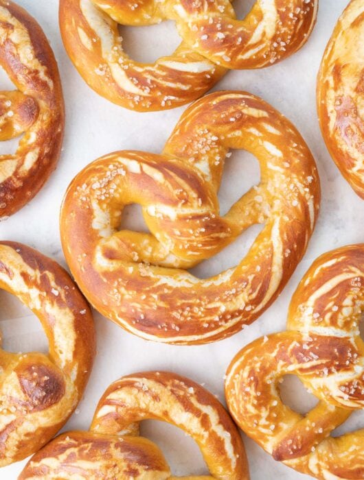 Soft pretzels on a piece of parchment paper.