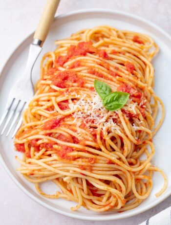 Spaghetti Pomodoro (from 'the Bear') on a white plate topped with parmesan.