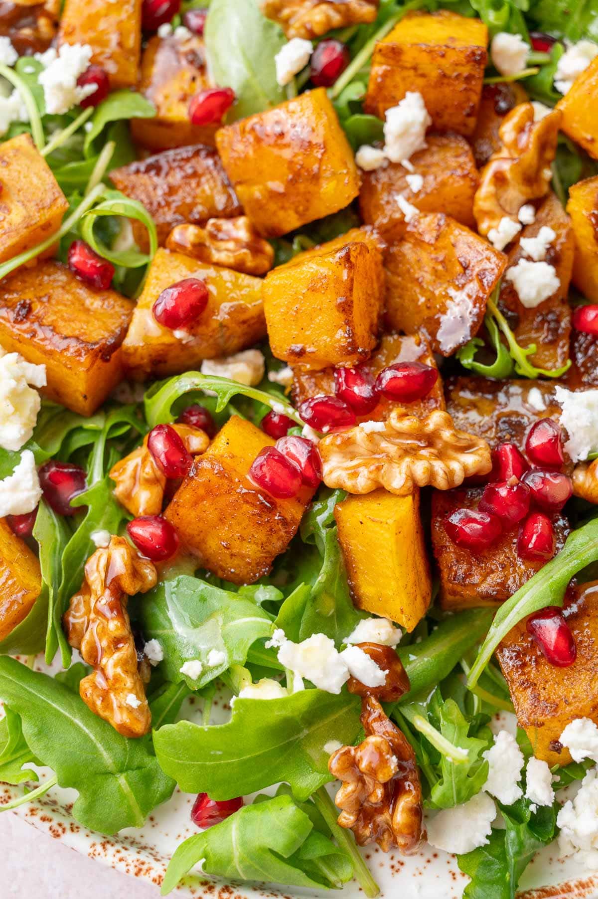 A close-up photo of Butternut Squash Salad on a white plate.