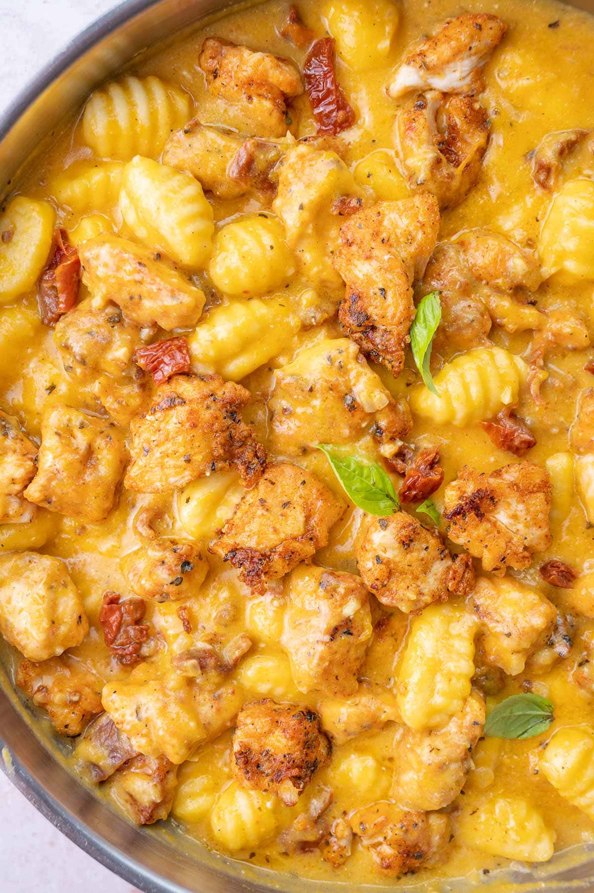 Chicken and Gnocchi in Creamy Butternut Squash Sauce in a frying pan.