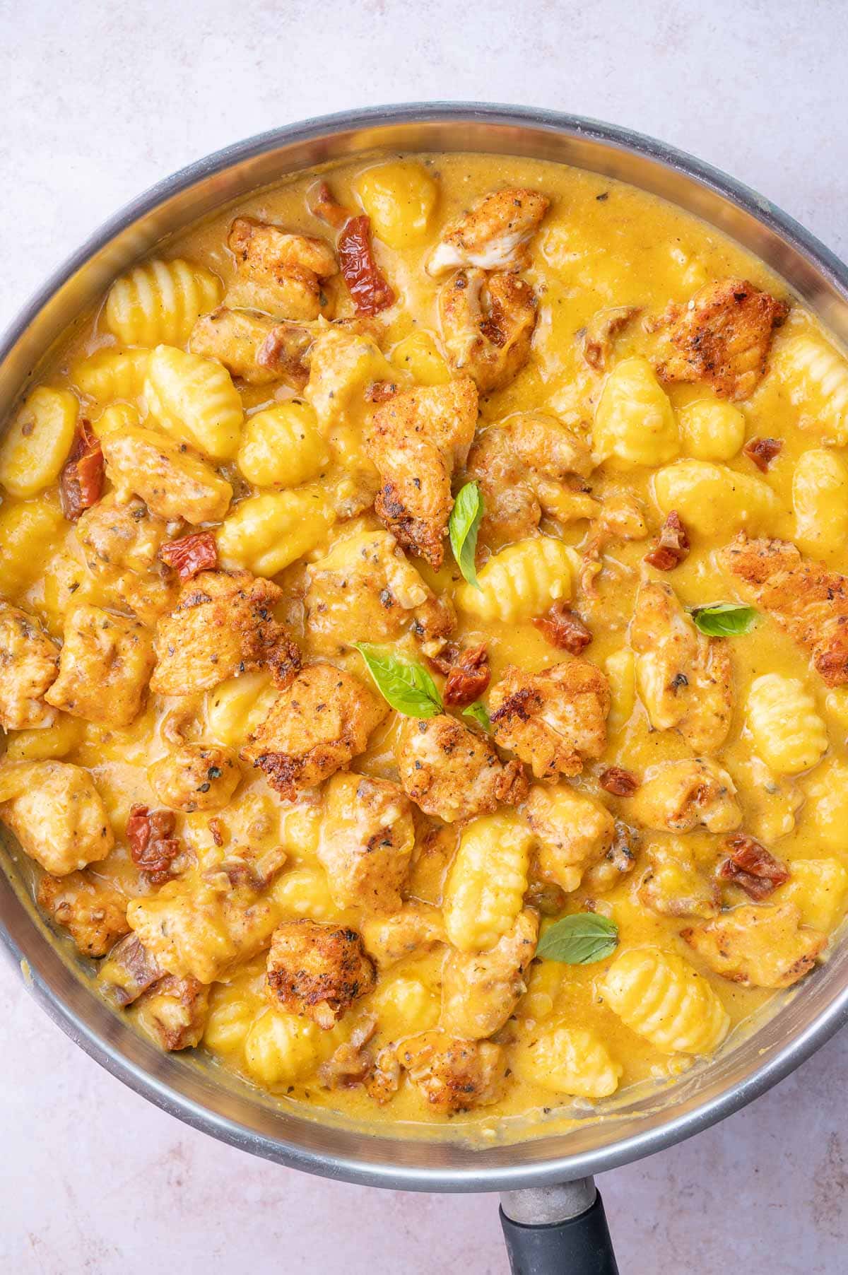 Chicken and Gnocchi in Creamy Butternut Squash Sauce in a frying pan.