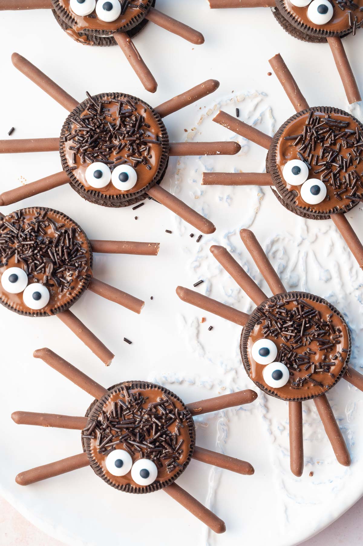 An overhead photo of oreo spiders on a white plate.