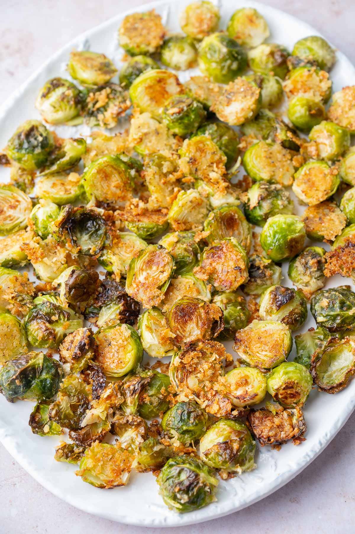 Parmesan roasted Brussels sprouts on a white plate.