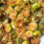 Parmesan roasted brussel sprouts on a white plate.