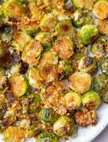 Parmesan roasted brussel sprouts on a white plate.