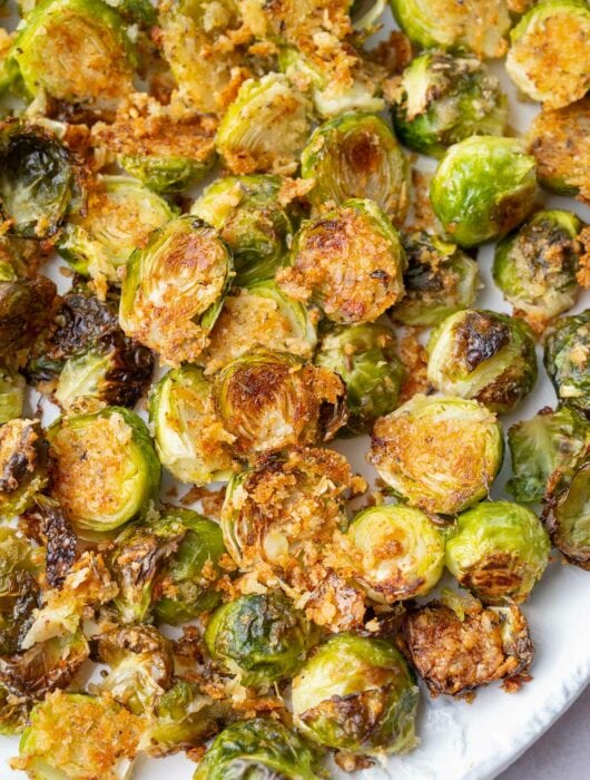 Parmesan roasted brussel sprouts on a white plate.