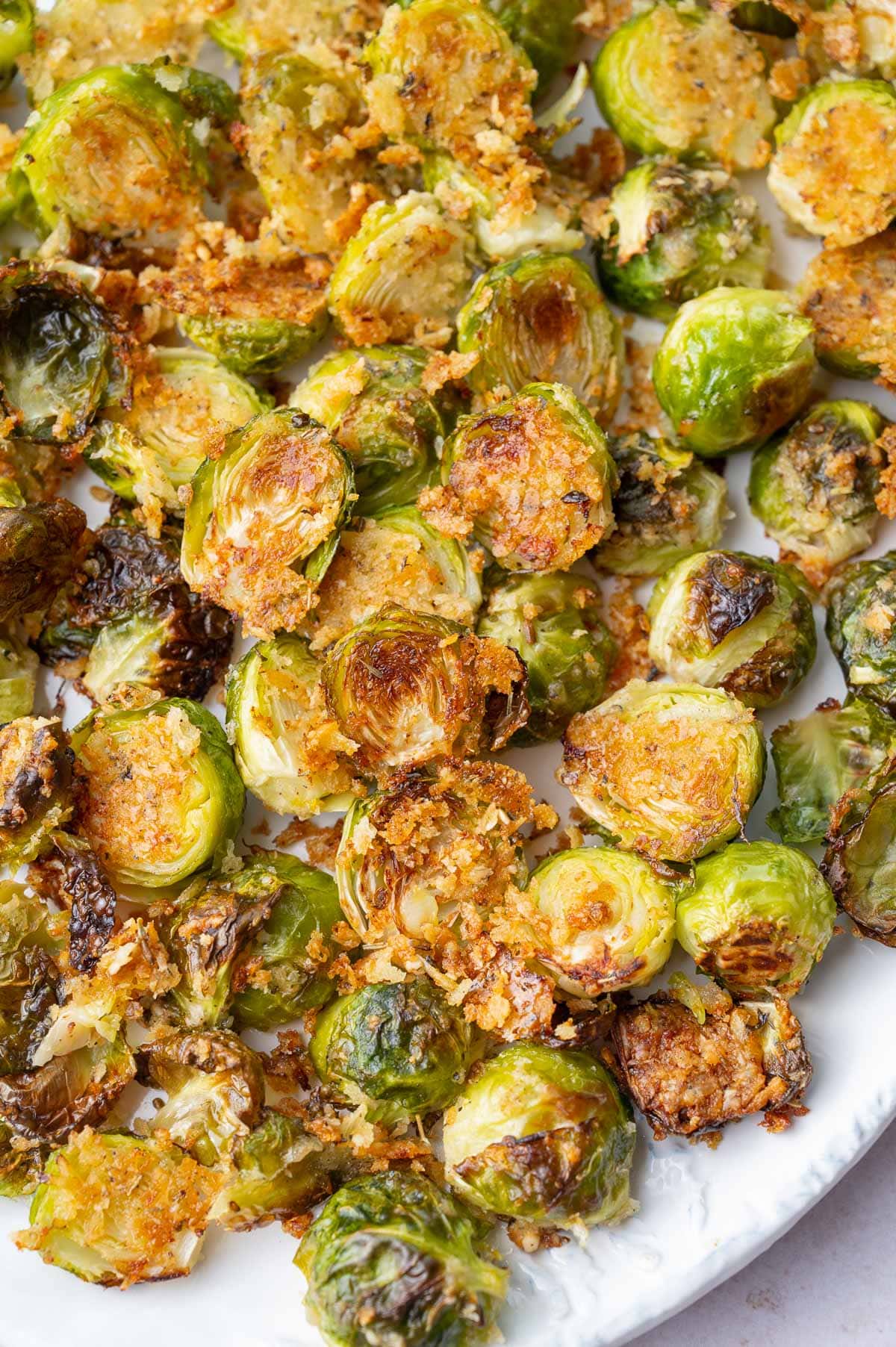 Roasted Brussels sprouts on a white plate.