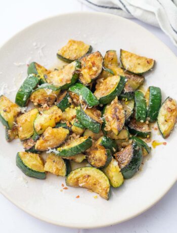 Sauteed zucchini on a beige plate.