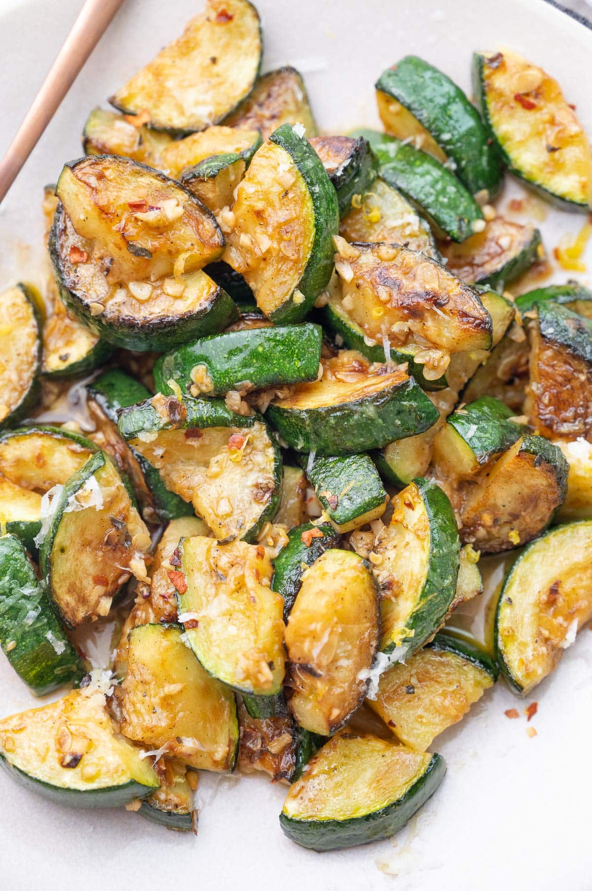 Sauteed zucchini on a beige plate.