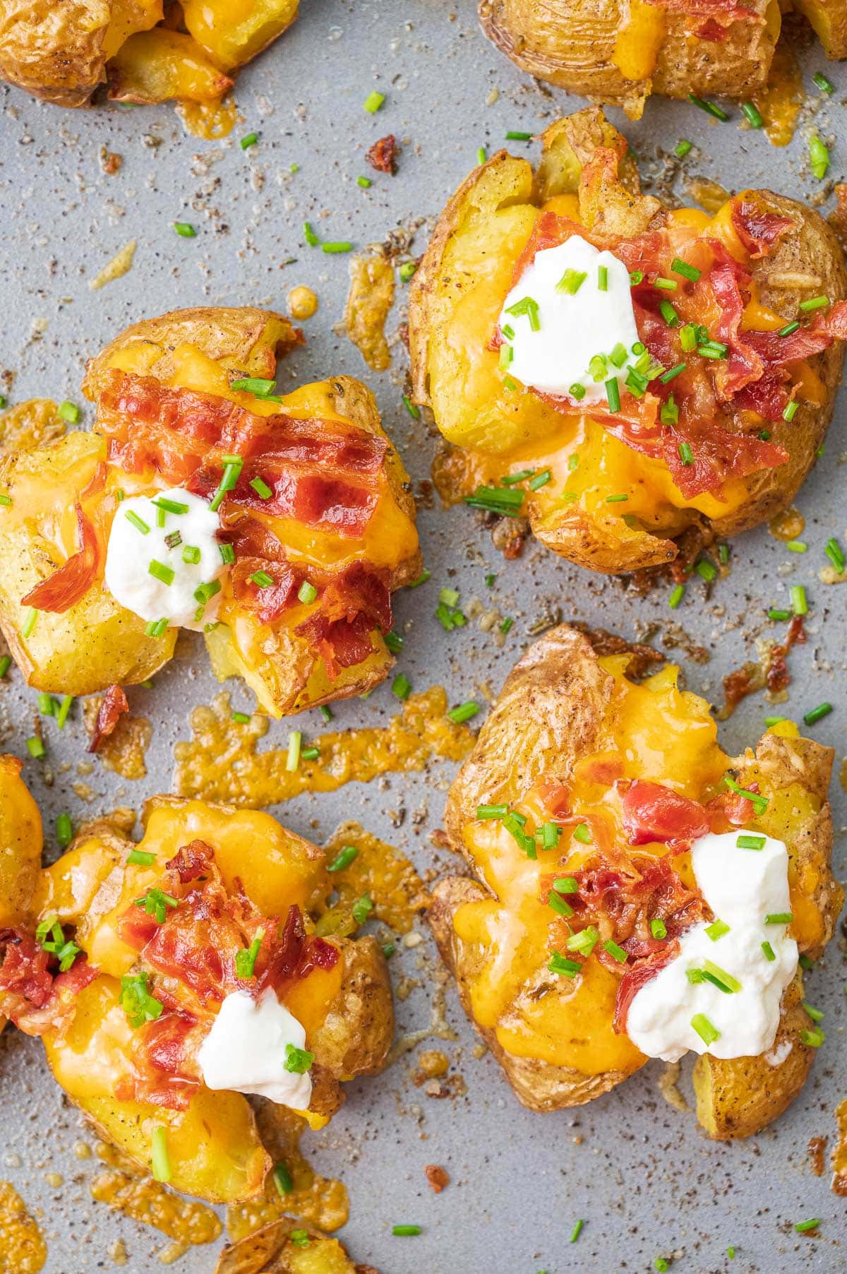 Loaded Smashed Potatoes on a baking sheet.