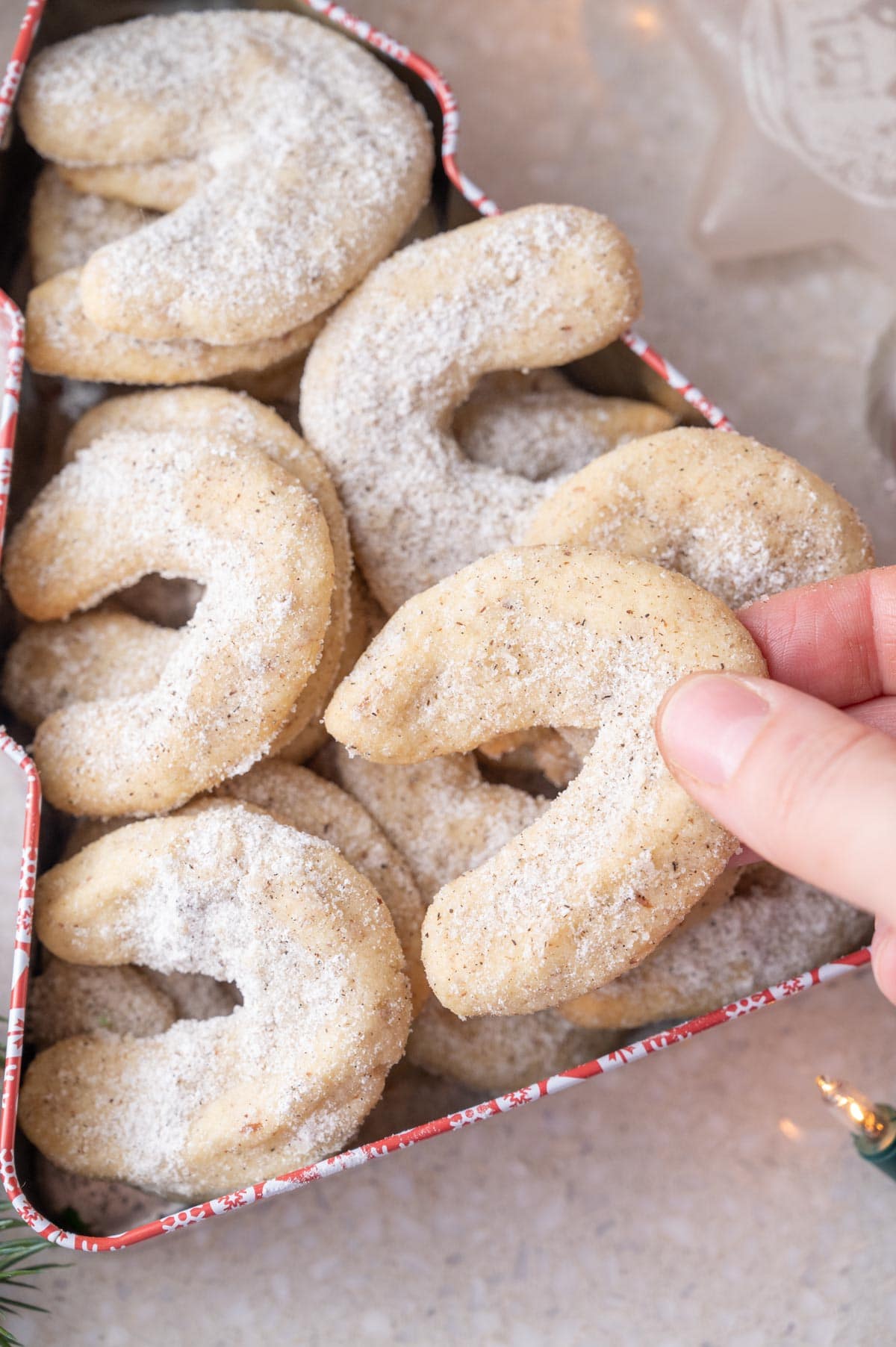 Vanillekipferl in a Christmas tree-shaped cookie tin.