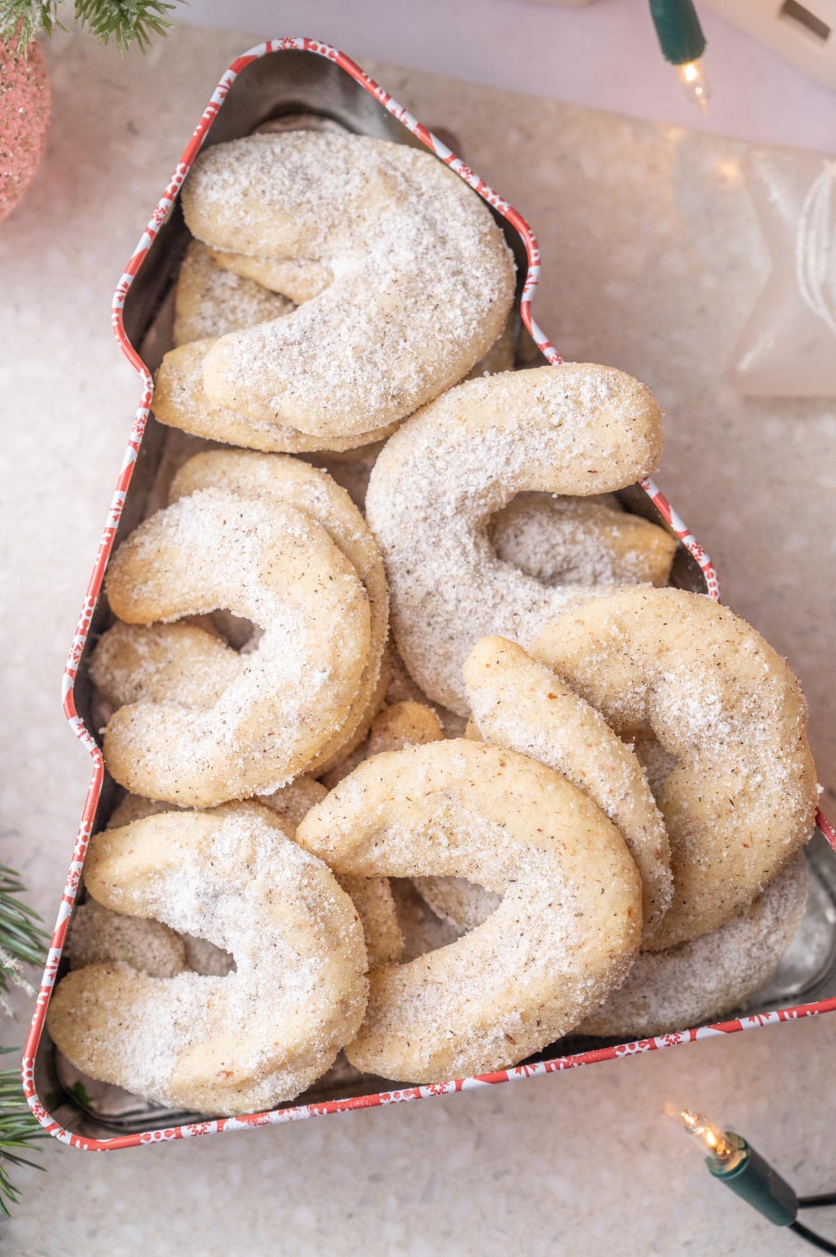 Vanillekipferl in a Christmas tree-shaped cookie tin.
