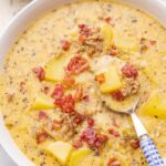 Cheeseburger chowder soup in a white bowl.