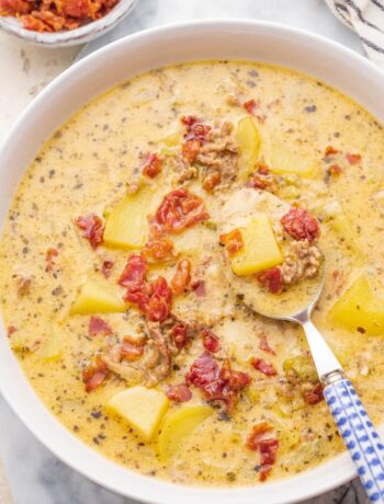 Cheeseburger chowder soup in a white bowl.