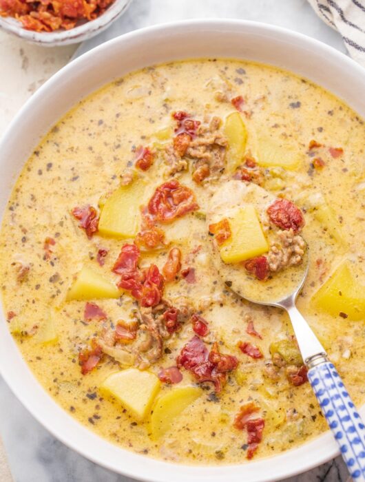 Cheeseburger chowder soup in a white bowl.