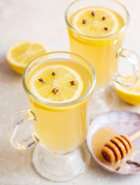 Two glasses with hot toddy cocktail.