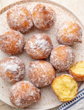 Ricotta doughnuts on a white plate.