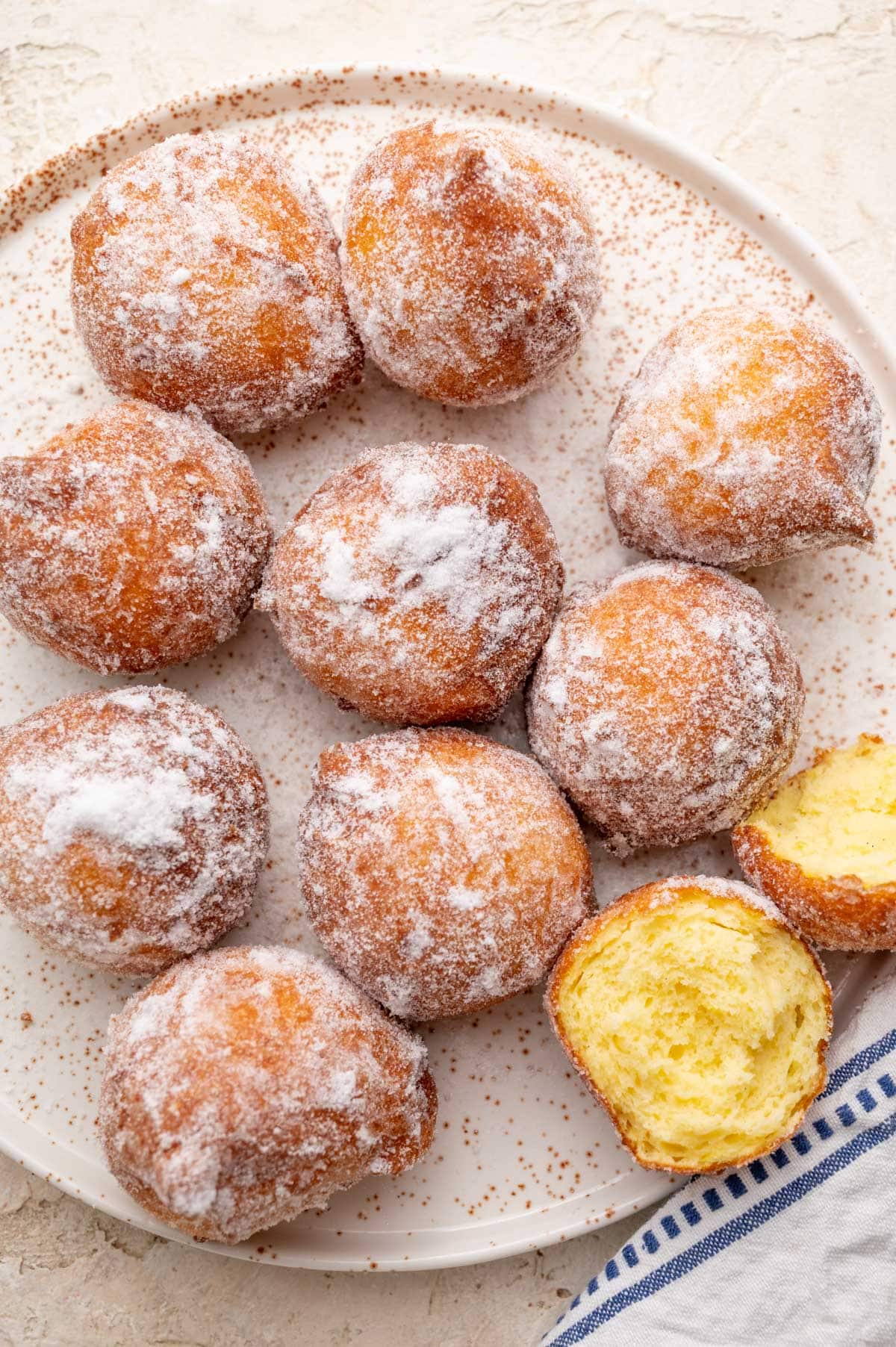 Ricotta doughnuts on a white plate.