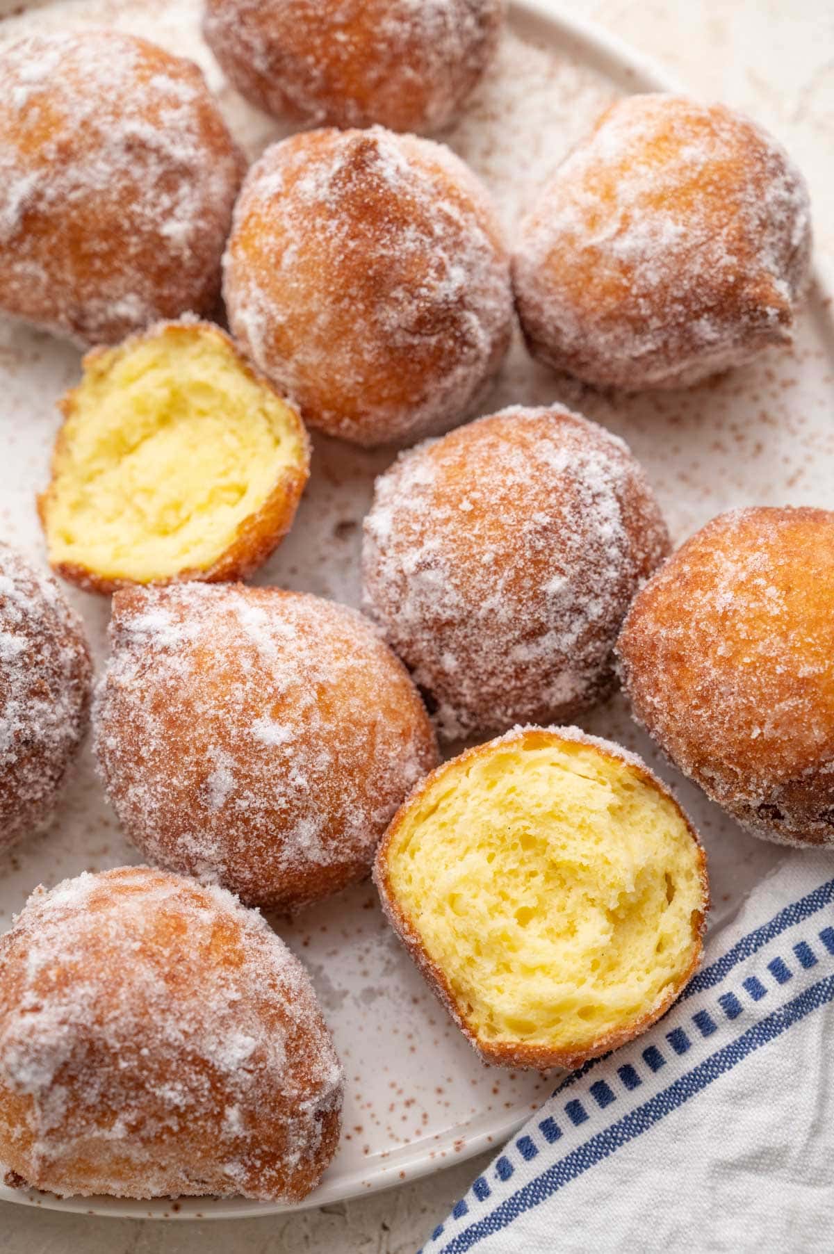 Ricotta doughnuts on a white plate.