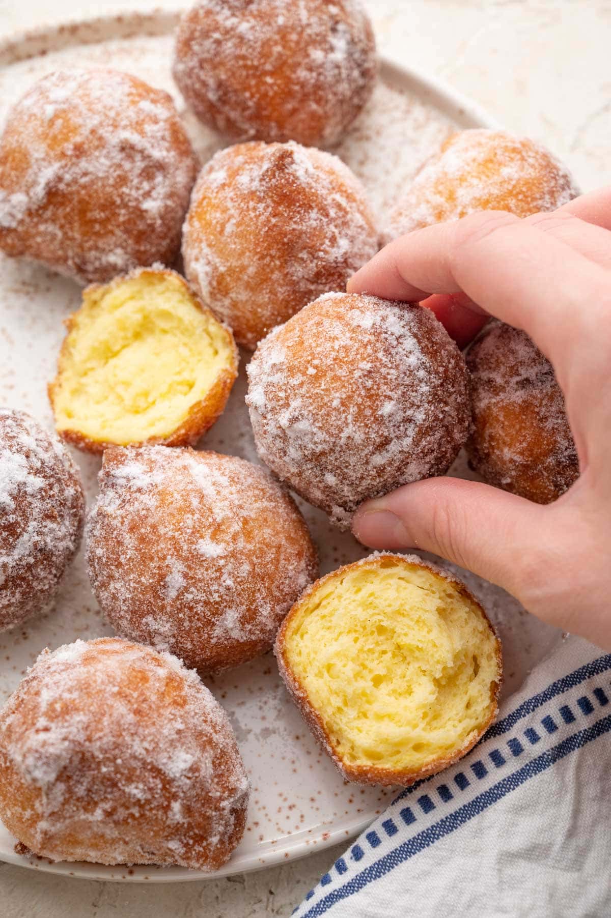 Ricotta doughnuts on a white plate.