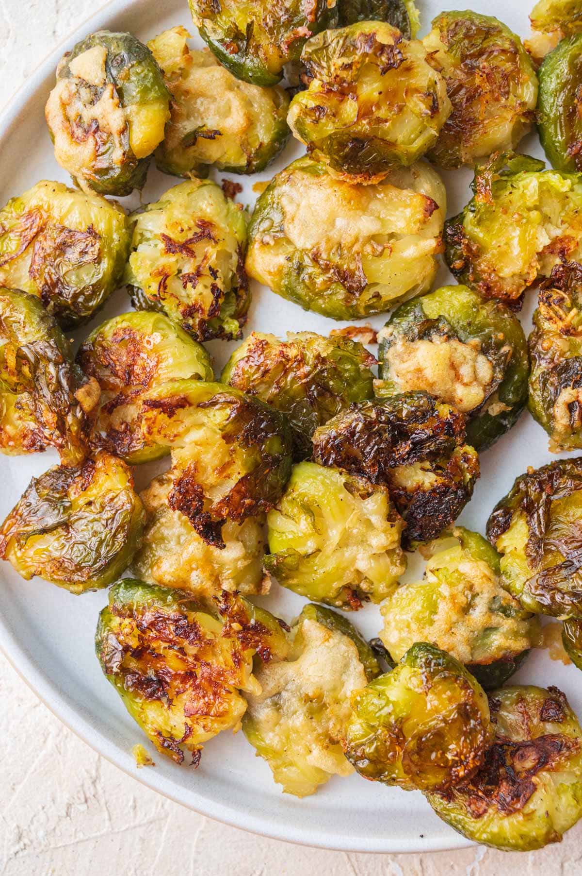 Smashed Brussel Sprouts on a white plate.