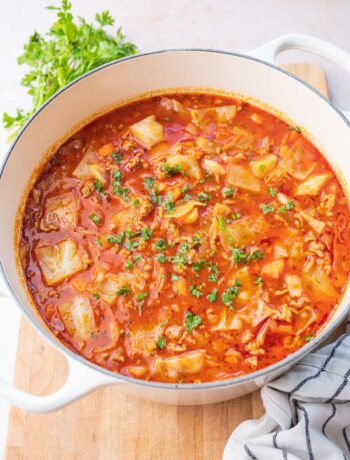 Cabbage roll soup in a white pot.