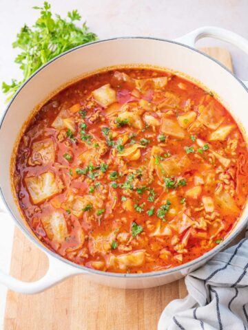 Cabbage roll soup in a white pot.
