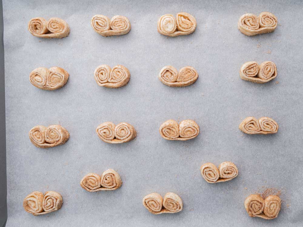 Palmiers cookies on a baking sheet lined with parchment paper ready to be baked.