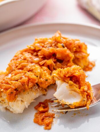 Polish fish ryba po grecku on a white plate.