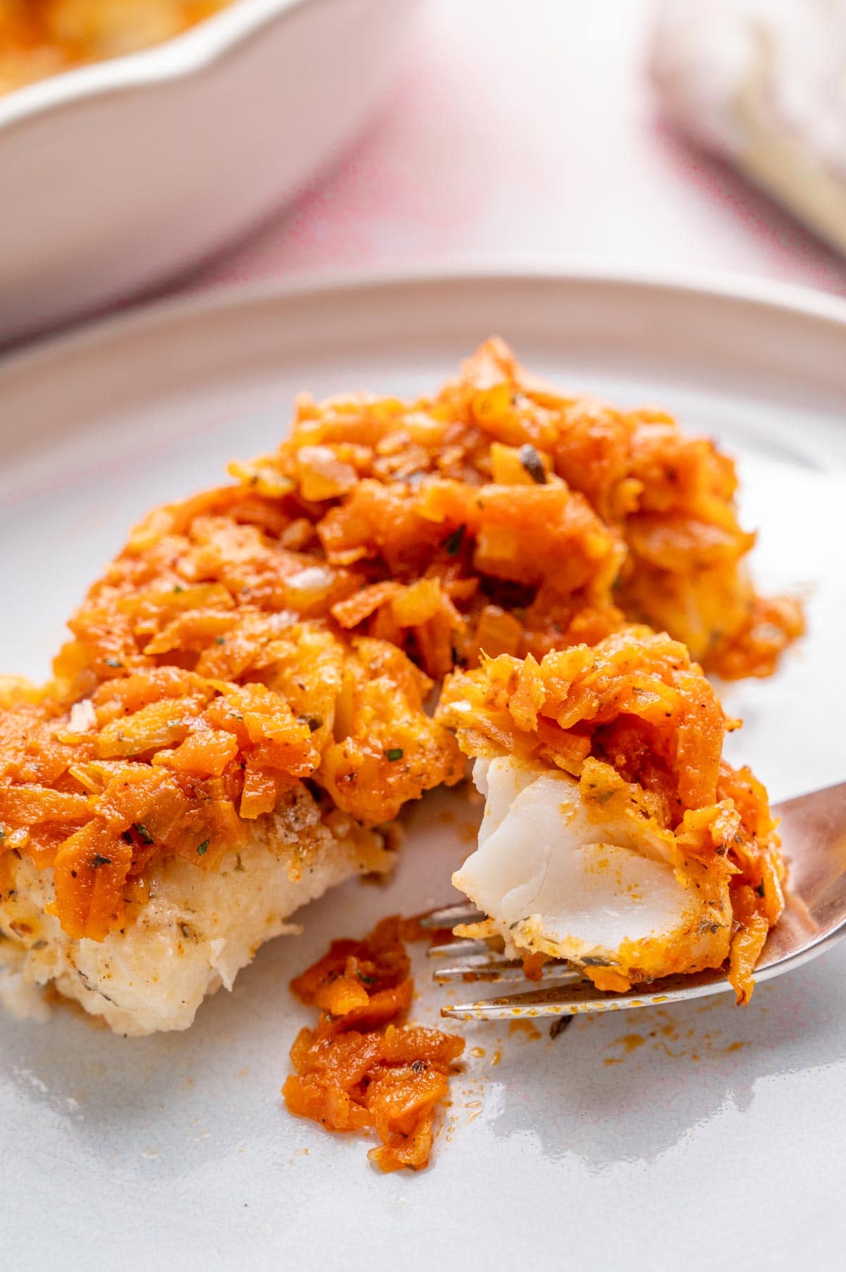 Polish fish ryba po grecku on a white plate.