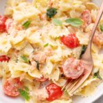 Smoked salmon pasta on a white plate.