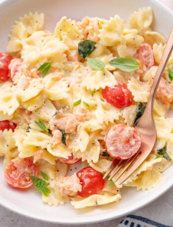 Smoked salmon pasta on a white plate.