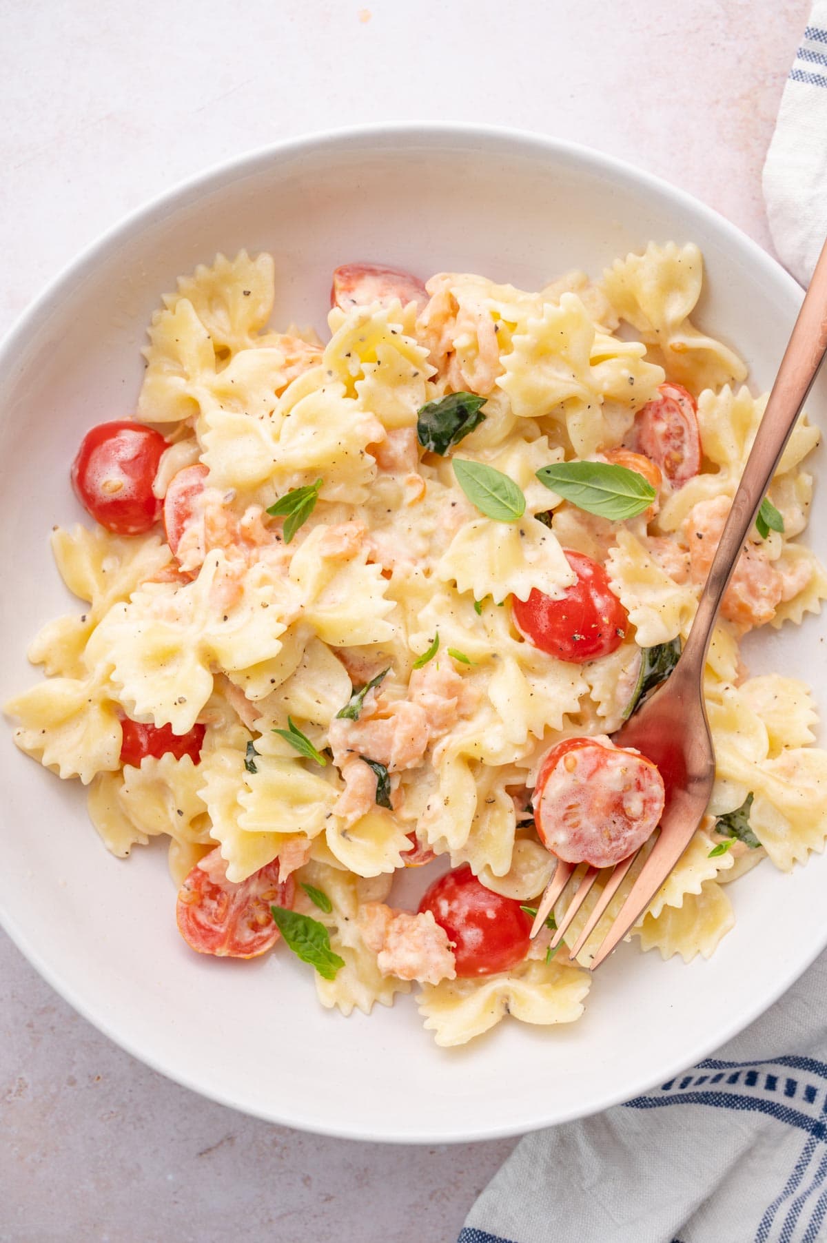 An overhead photo of smoked salmon pasta on a white plate.