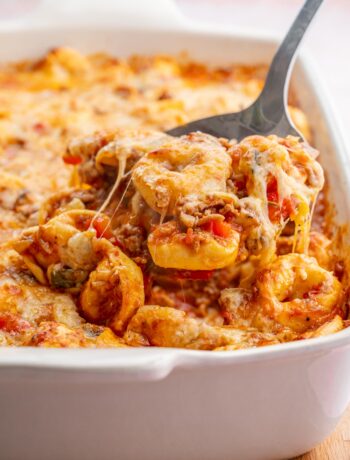 Tortellini bake in a white casserole dish.