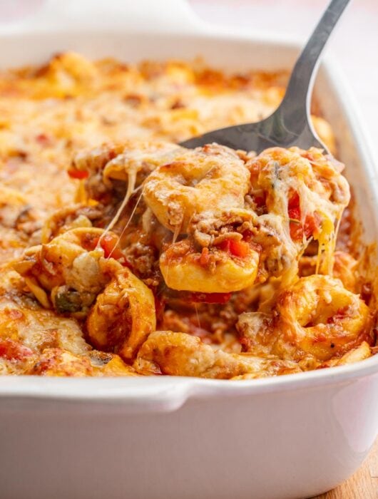 Tortellini bake in a white casserole dish.