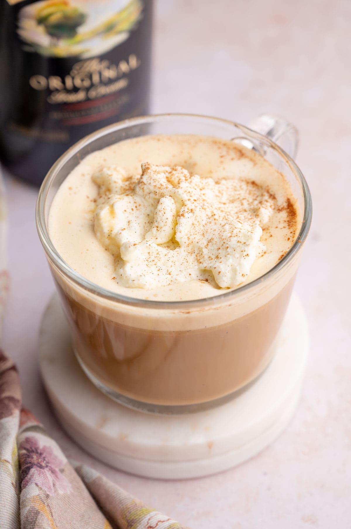 Baileys Coffee in a coffee mug. Baileys liqueur in the background.