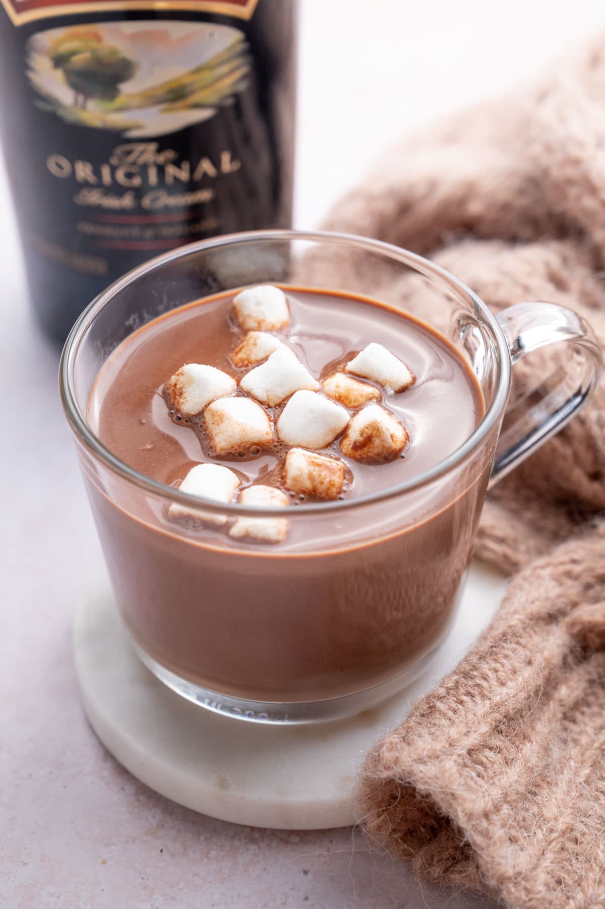 Baileys hot chocolate in a glass topped with marshmallows.