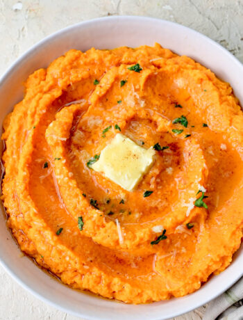 Mashed carrots in a white bowl.