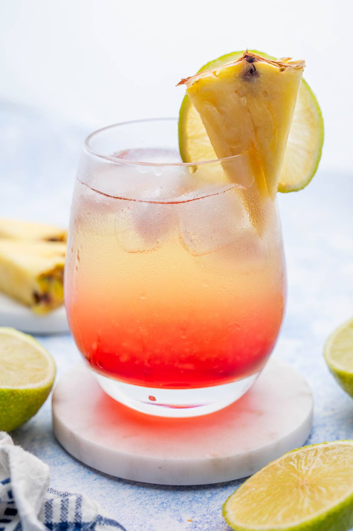 Layered pinneapple vodka drink in a glass.