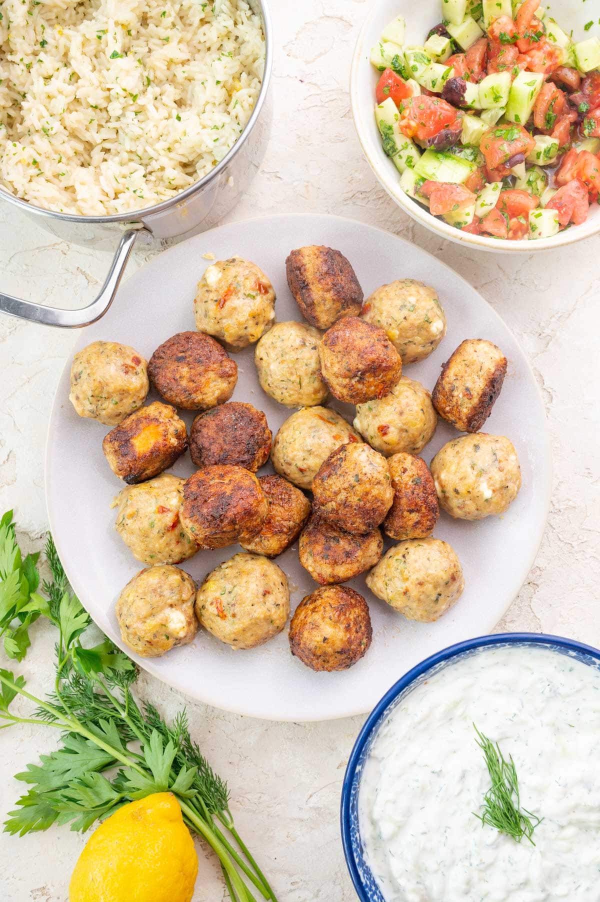 Greek Chicken Meatballs, lemon rice, tzatziki and tomato cucumber salad.