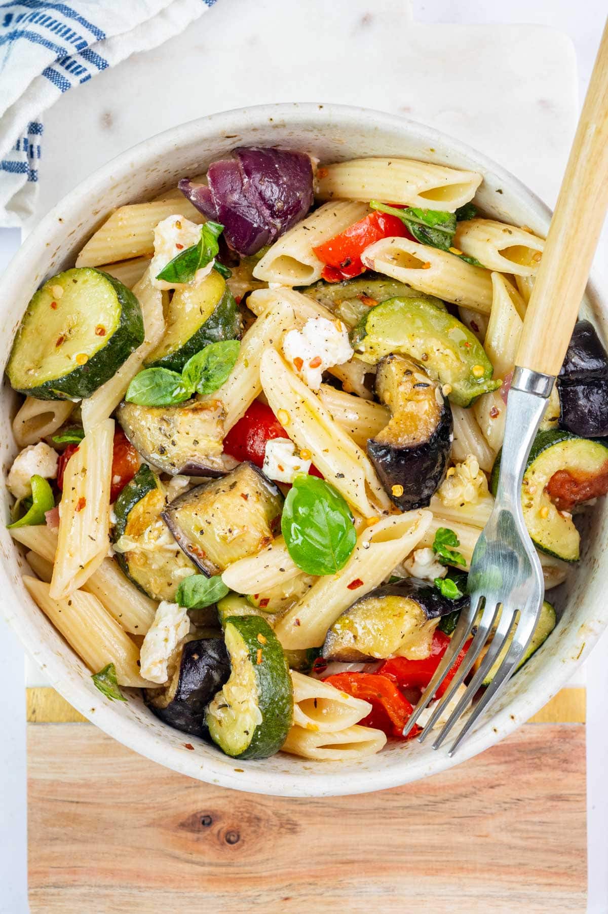 Roasted Vegetable Pasta in a white bowl with a fork on the side.