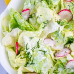 Butter lettuce salad in a white bowl.