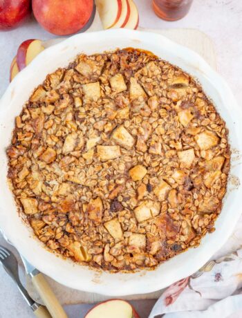 Baked apple oatmeal in a white baking dish.