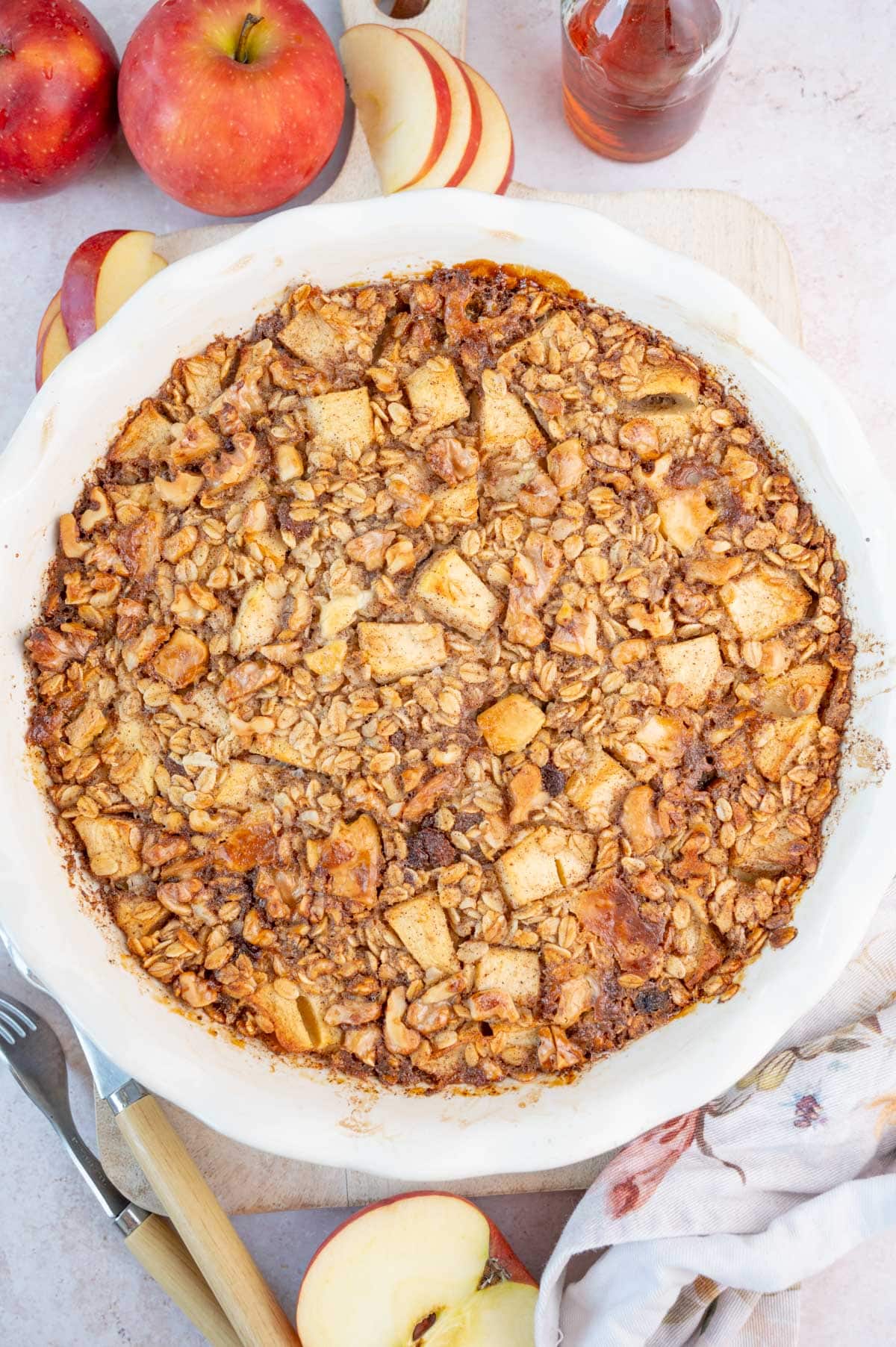 An overhead photo of apple baked oatmeal in a white baking dish.