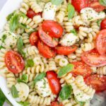 Caprese pasta salad in a white bowl.