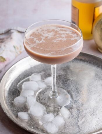 Brandy Alexander cocktail in a coupe glass on a silver tray.